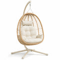 Silla colgante de ratán sintético con cojines beige y estructura metálica, 195x95x90 cm